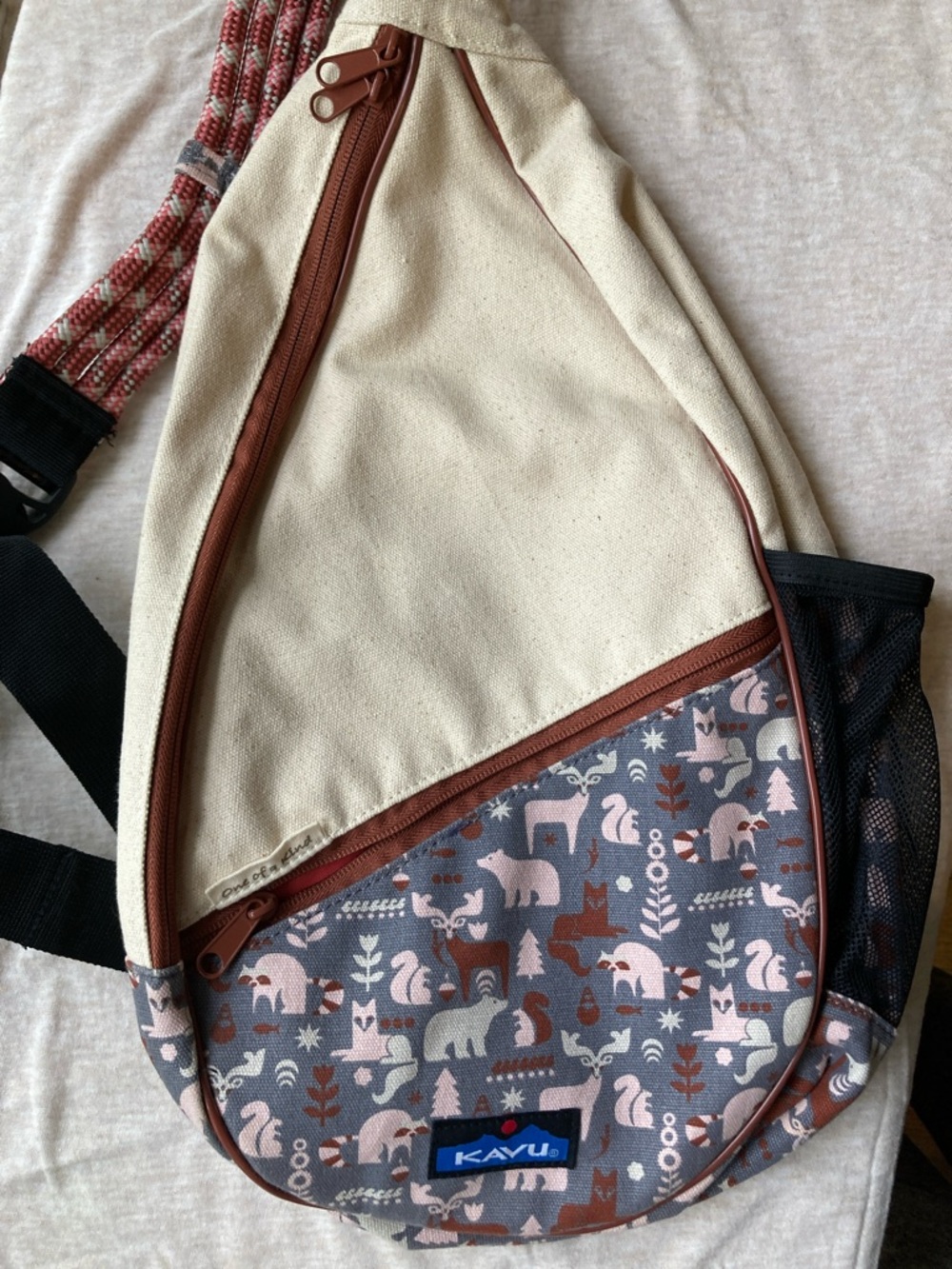 Kavu Beige and Rust Canvas Sling Backpack with Animal Print